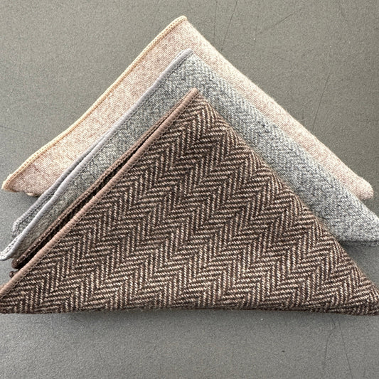 This is a set of three wool pocket squares in a herringbone design in grey, cream and brown. Ideal as EDC hanks for everyday carry