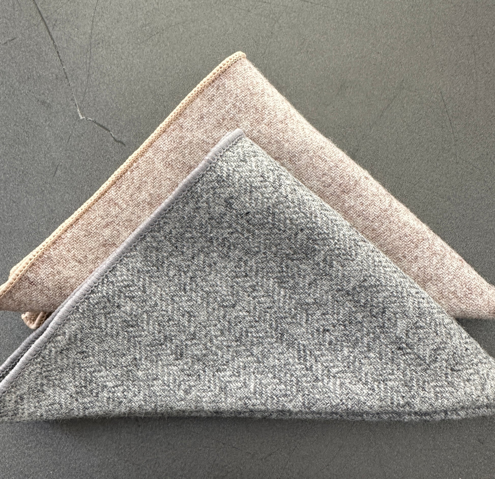 This is a set of two wool pocket squares in a herringbone design in grey, cream and brown. Ideal for mens gifts. The set makes a perfect EDC hank set for everyday use