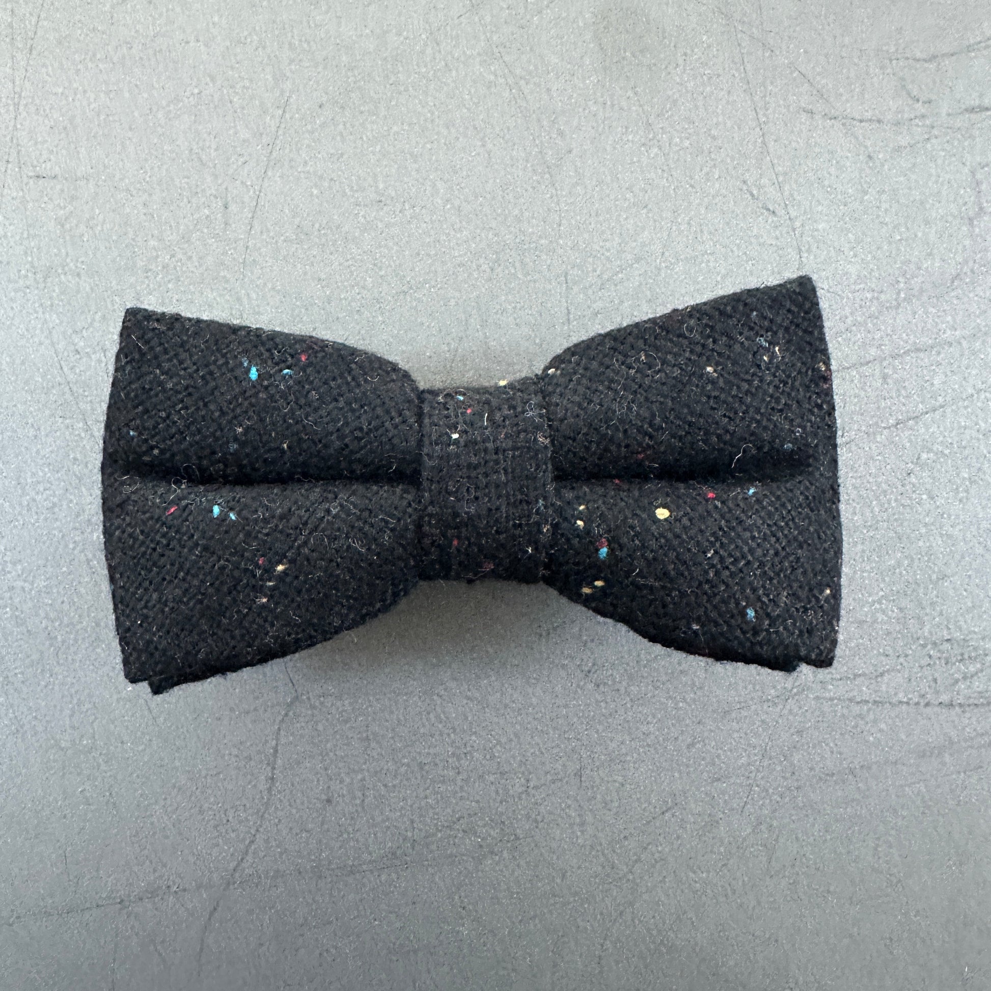 A black wool pre-tied bow tie for men.