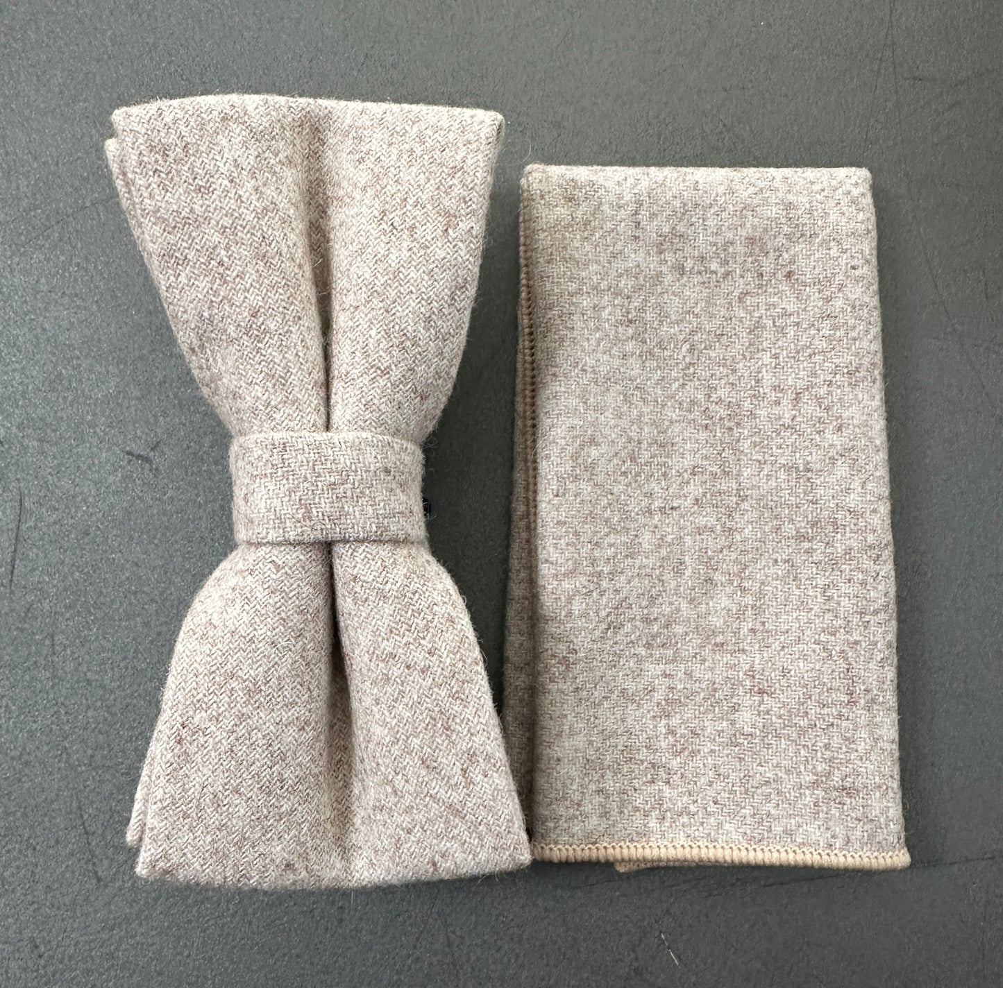 A cream wool bow tie and pocket square set for weddings and groomsmen.