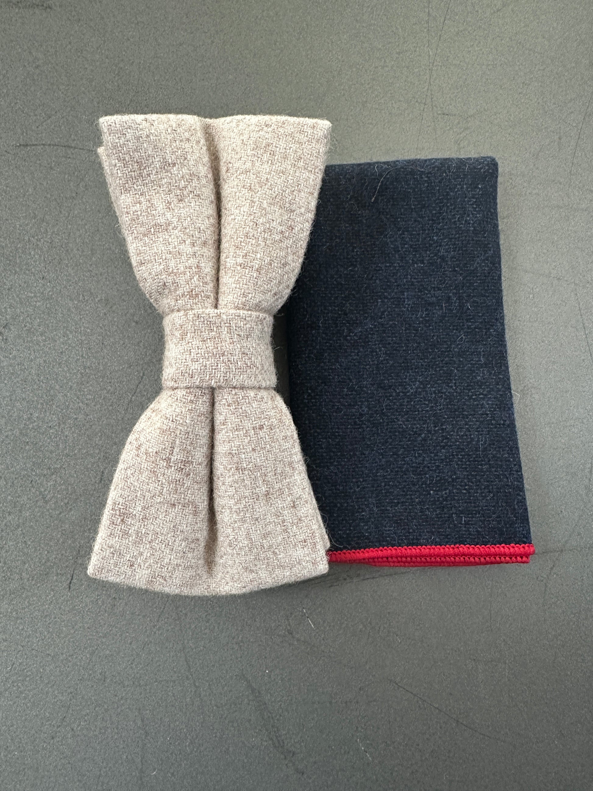 Navy wool bow tie and pocket square with red trim – perfect for weddings and formal wear.
