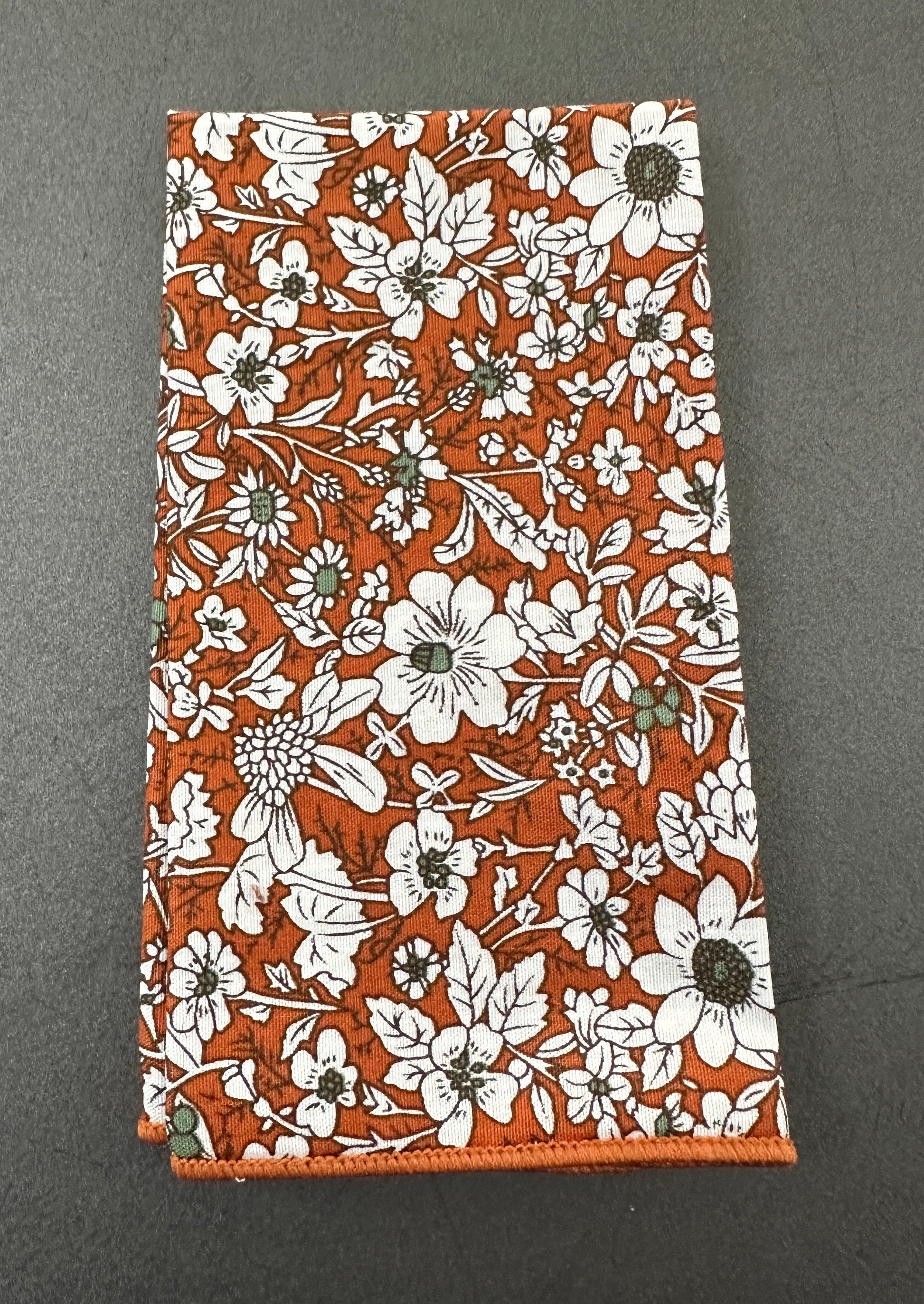 An orange floral pocket square to match our range of burnt orange ties ideal for weddings.