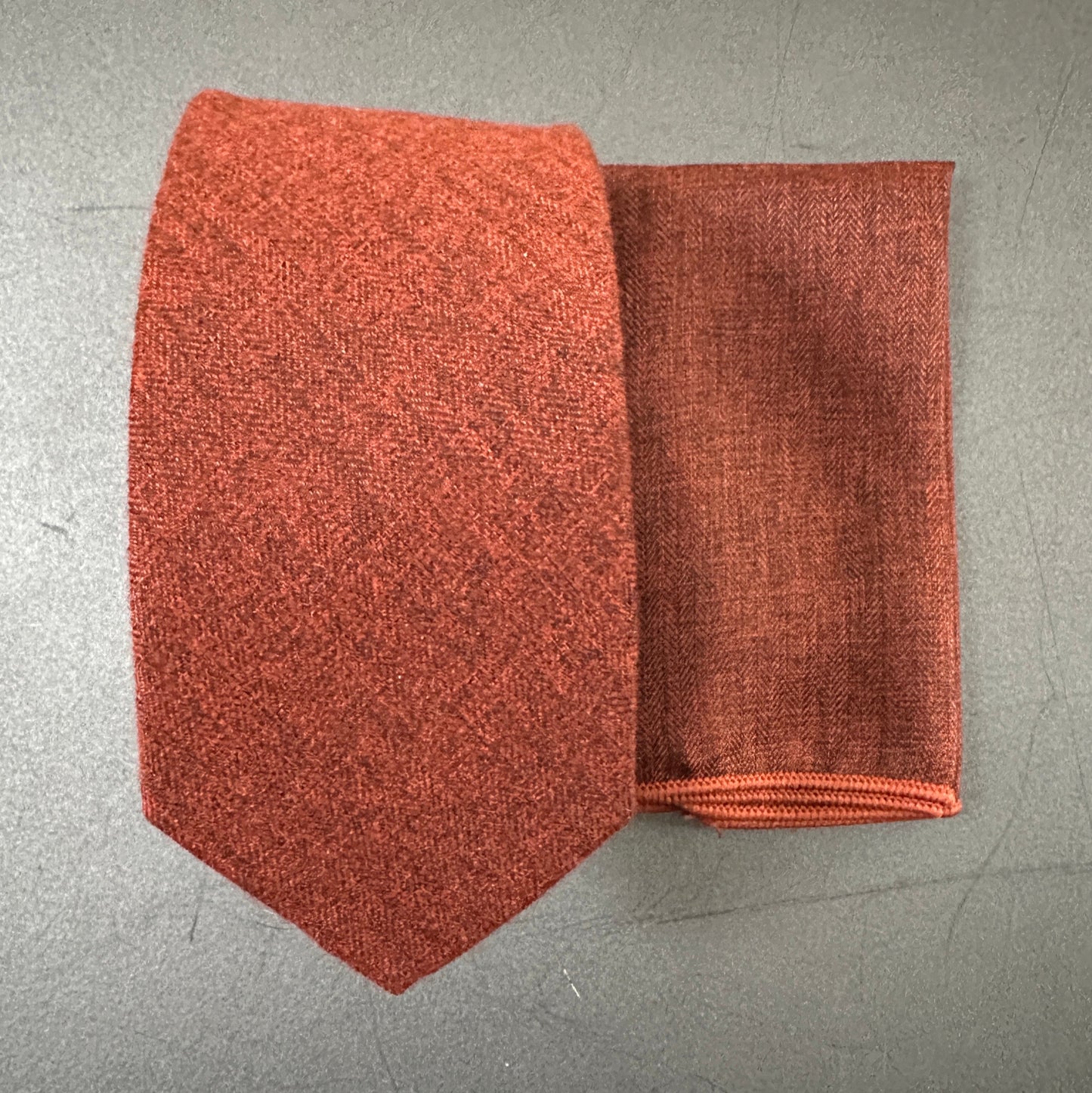 A burnt orange mens tie and pocket square set ideal for wedding ties. Perfect orange weeding ties for grooms.