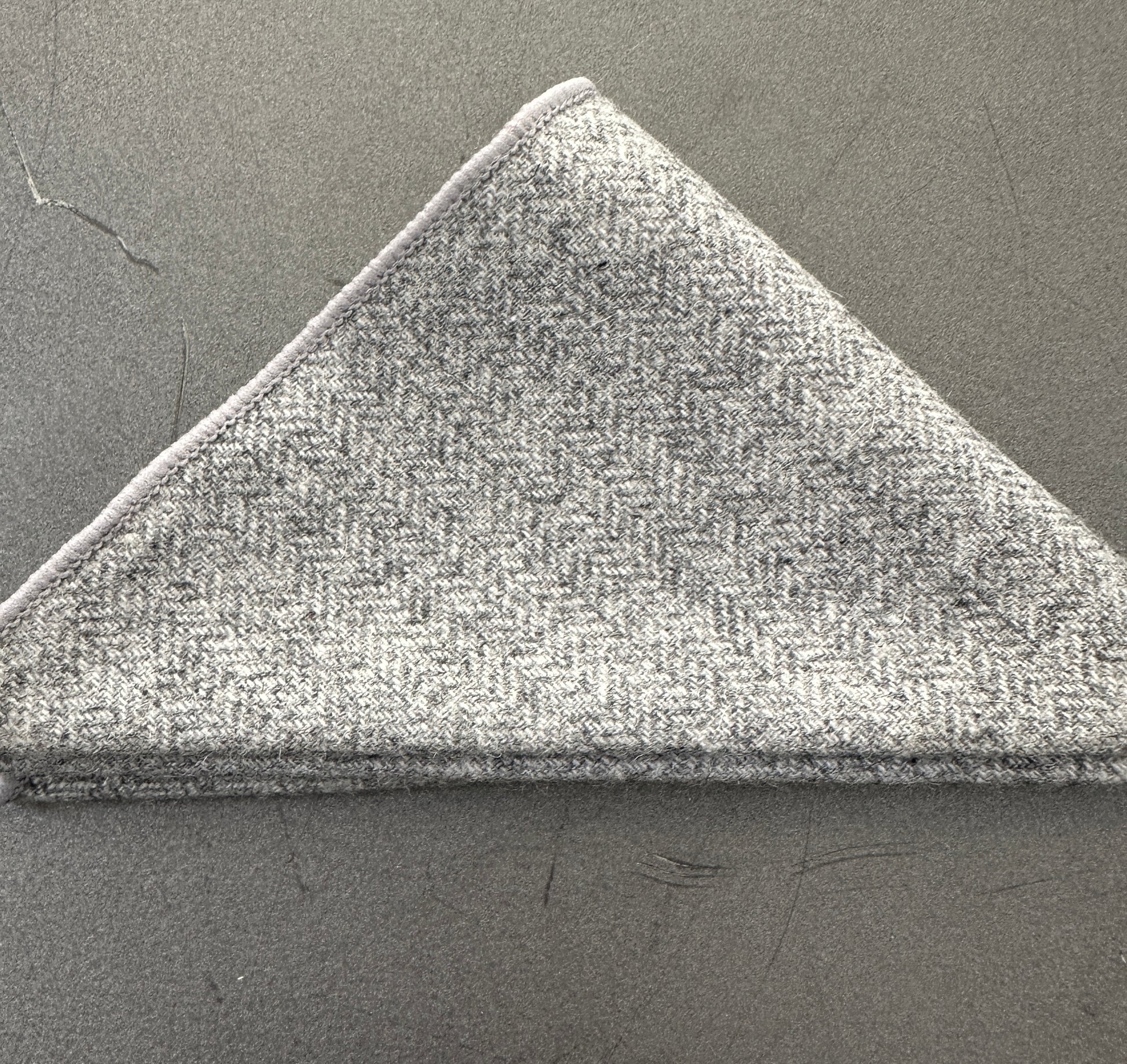 A grey herringbone wool pocket square ideal as an EDC hank for every day carry. This comes with free gift wrap and can be bought in a set of three handkerchiefs.