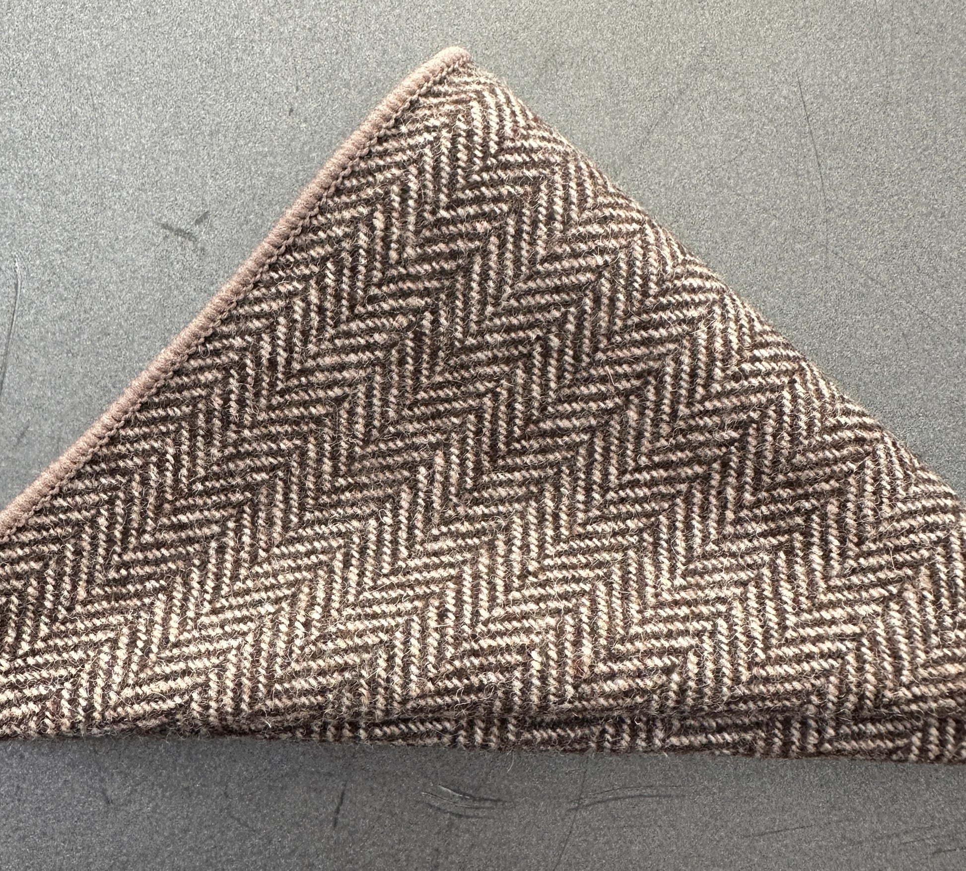 A brown herringbone wool pocket square ideal as an EDC hank for every day carry. This comes with free gift wrap and can be bought in a set of three handkerchiefs.