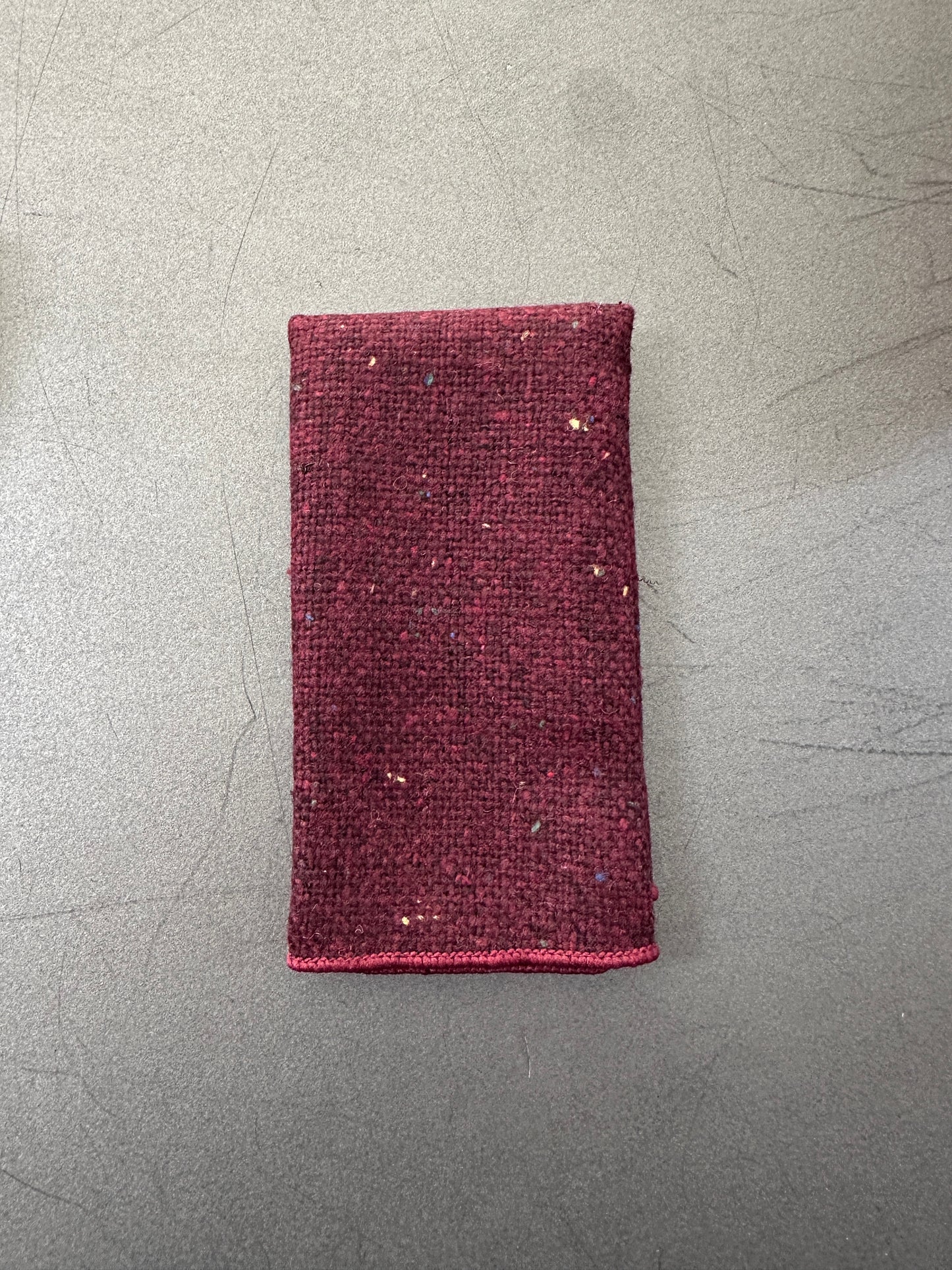 A red wool pocket square in flecked wool ideal as an edc hank.