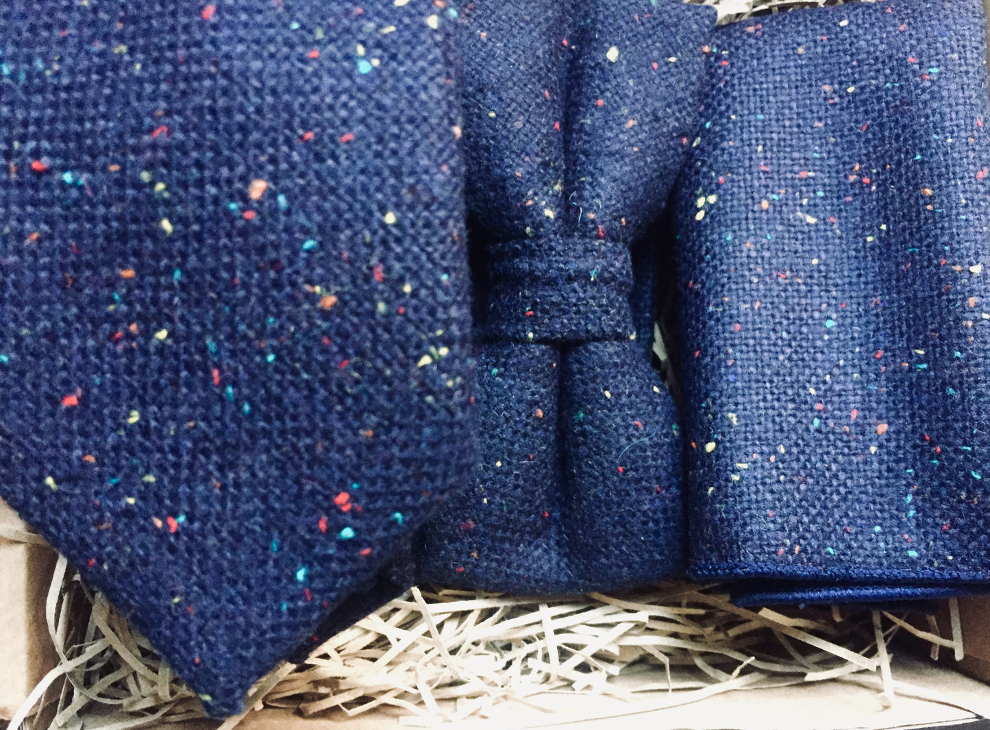 A navy, flecked wool men's tie, bow tie and pocket square. The set includes free gift wrapping and so is perfect for men's giifts, wedding ties and grooms men gifts. Our ties are handmade at Daisy and Oak Studio