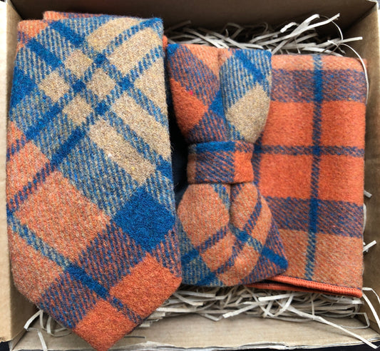 This is an amazing bow tie, tie and pocket square set. It's highly original and is in a popular burnt orange colour with a navy check. THe ties matches perfectly with a navy suit. The set comes with free gift wrap and is handmade at the Daisy and Oak Studio, UK