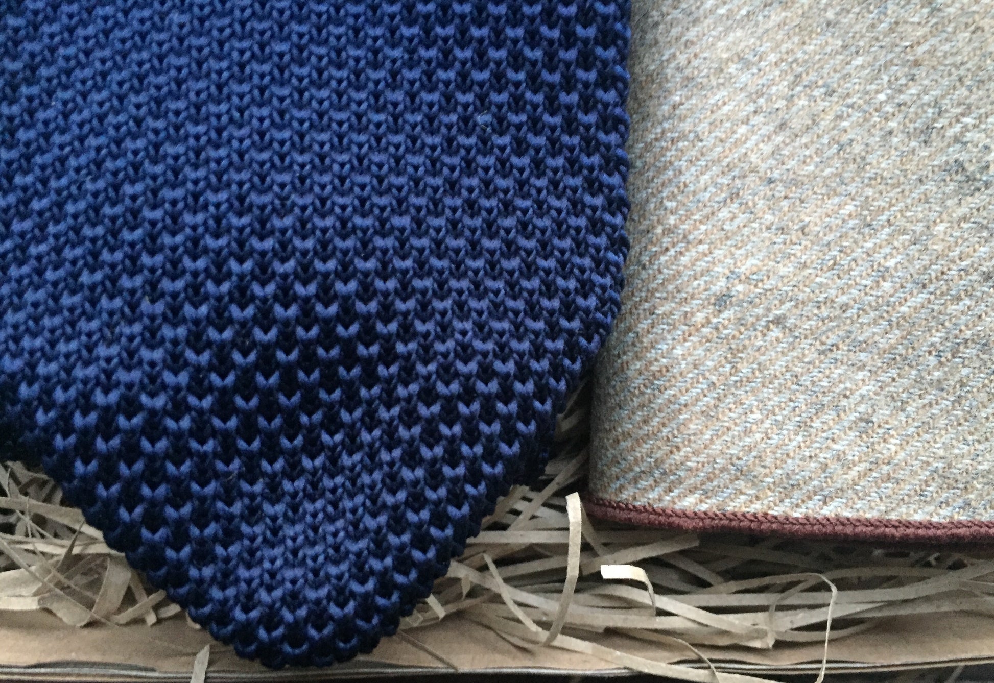 A navy blue men's knitted tie and beige wool pocket square handkerchief. Our ties come with free gift wrapping and make ideal presents for, men, groomsmen and as wedding ties. Daisy and Oak Studio.