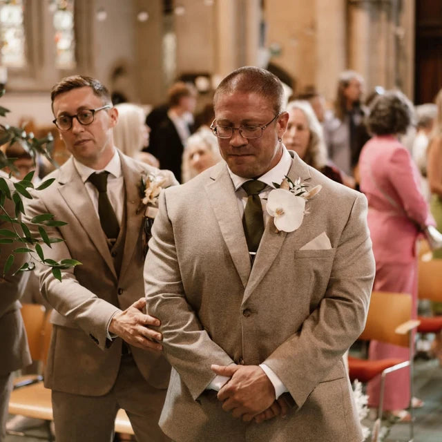 A groom wearing a green knitted tie at a wedding. Our ties are handmade and perfect gifts for men.. They come with free gift wrapping and are made by Daisy and Oak Studio.